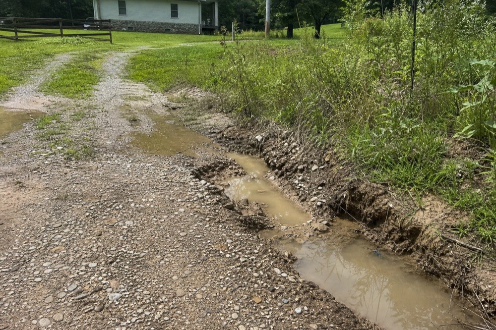 drainage & gravel driveway work before — overgrown property near De Mossville, KY