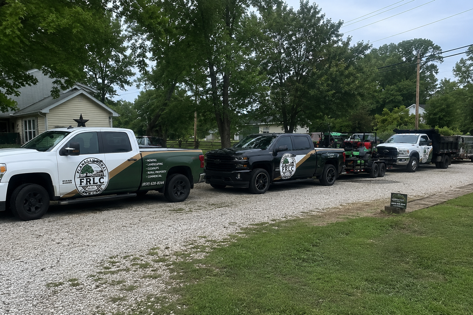 Flanagan Rural Lawn Care fleet of branded trucks, trailers, and mowing equipment